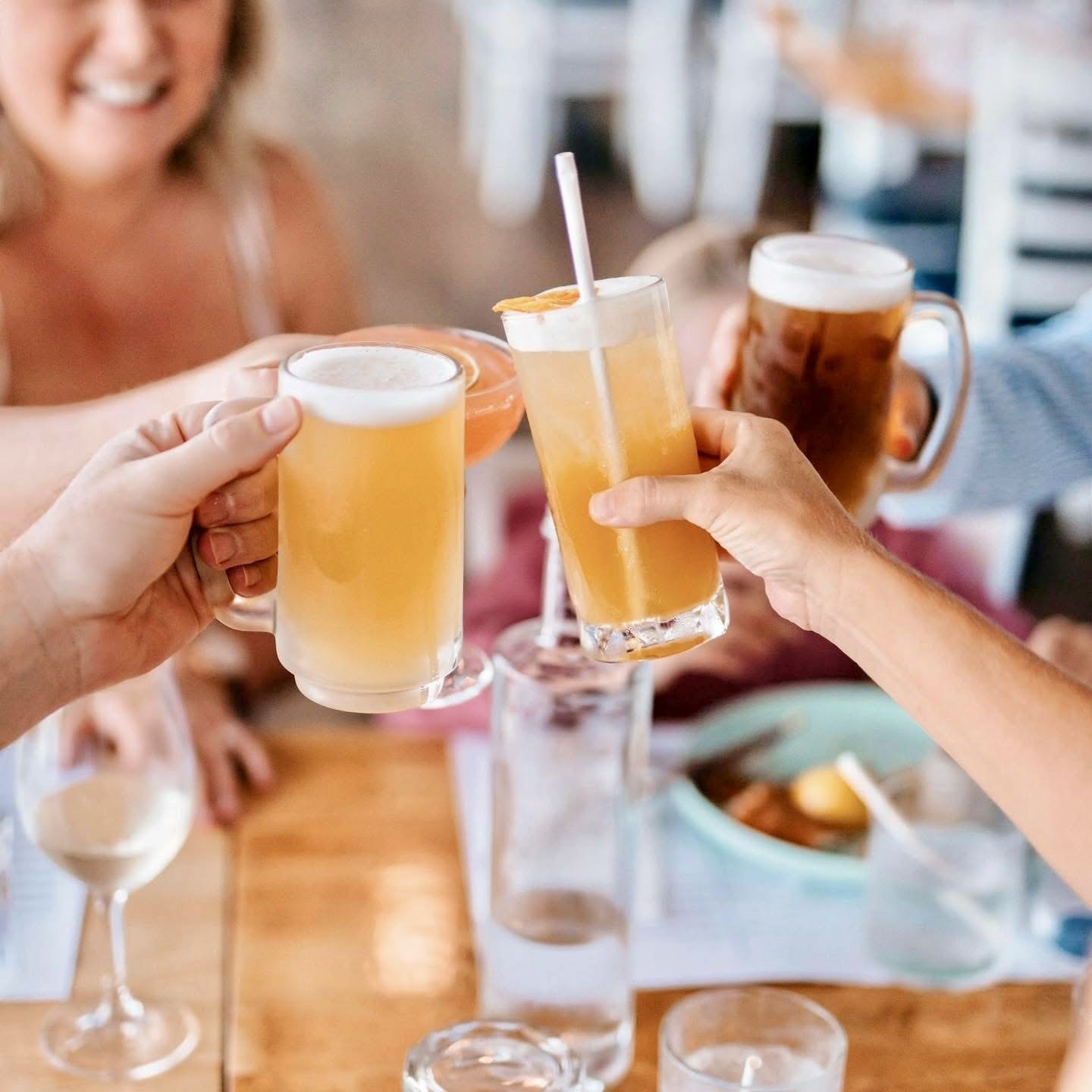 Group of friends toasting with beers, cocktails and iced drinks at Rockpool Pavilion