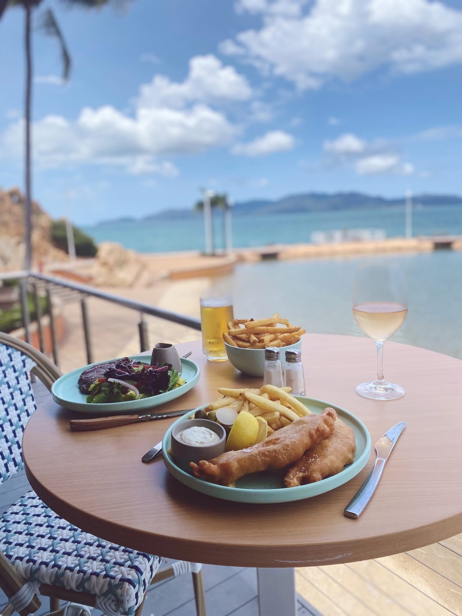 Beer-battered fish and chips with white wine overlooking the rockpool