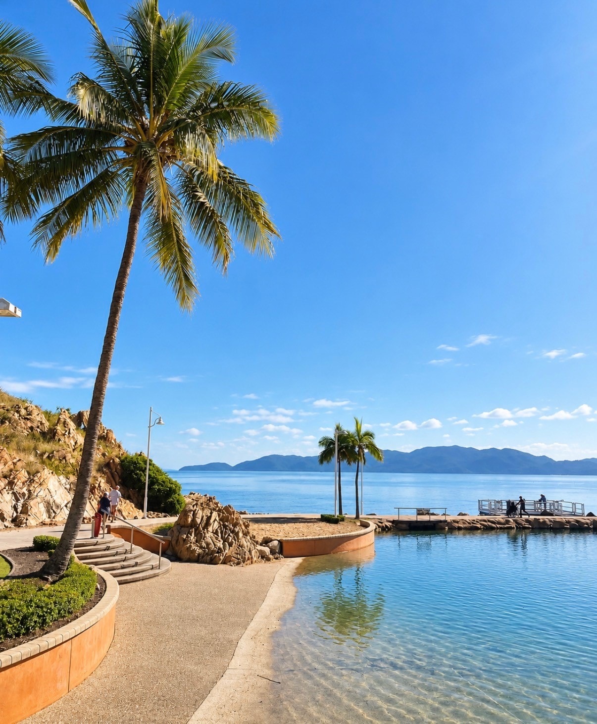 The Strand rockpool with palm trees and calm bay